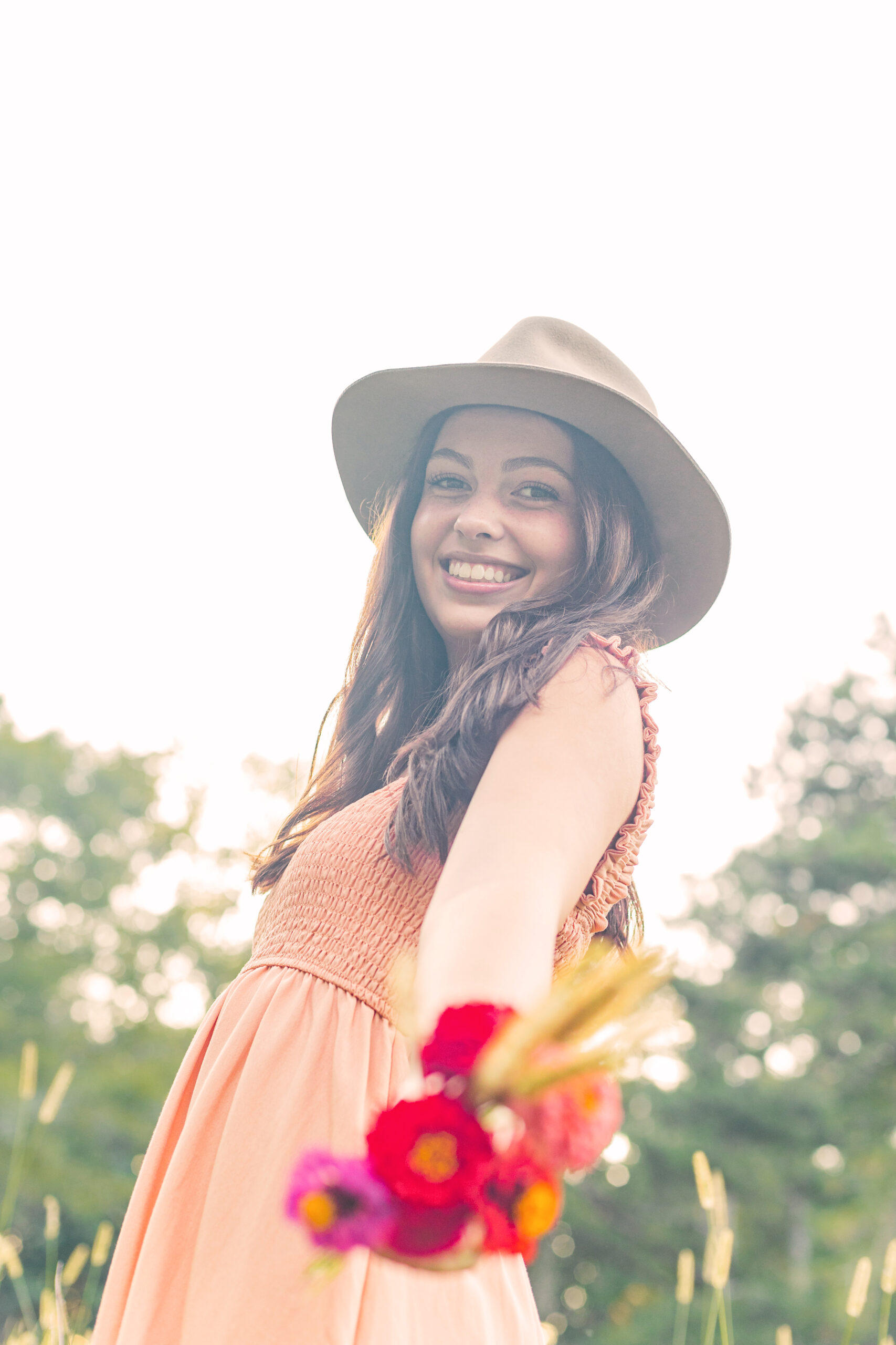 High school senior girl holding a bouquet of flowers for senior portraits