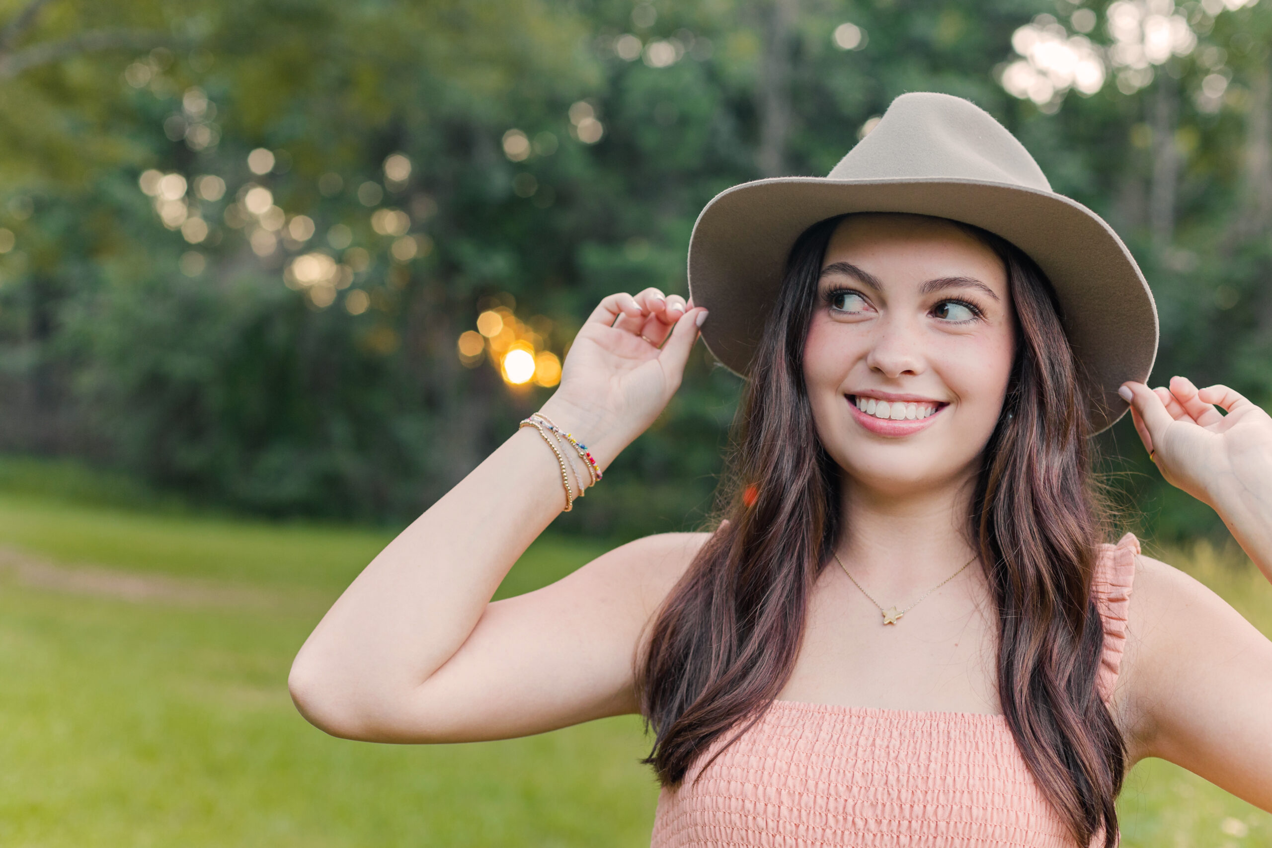 High School Senior girl wearing a hat for senior portraits