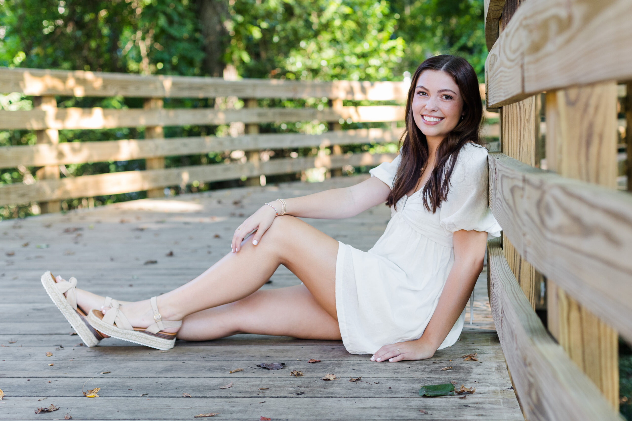 High School Senior Girl sitting on a bridge