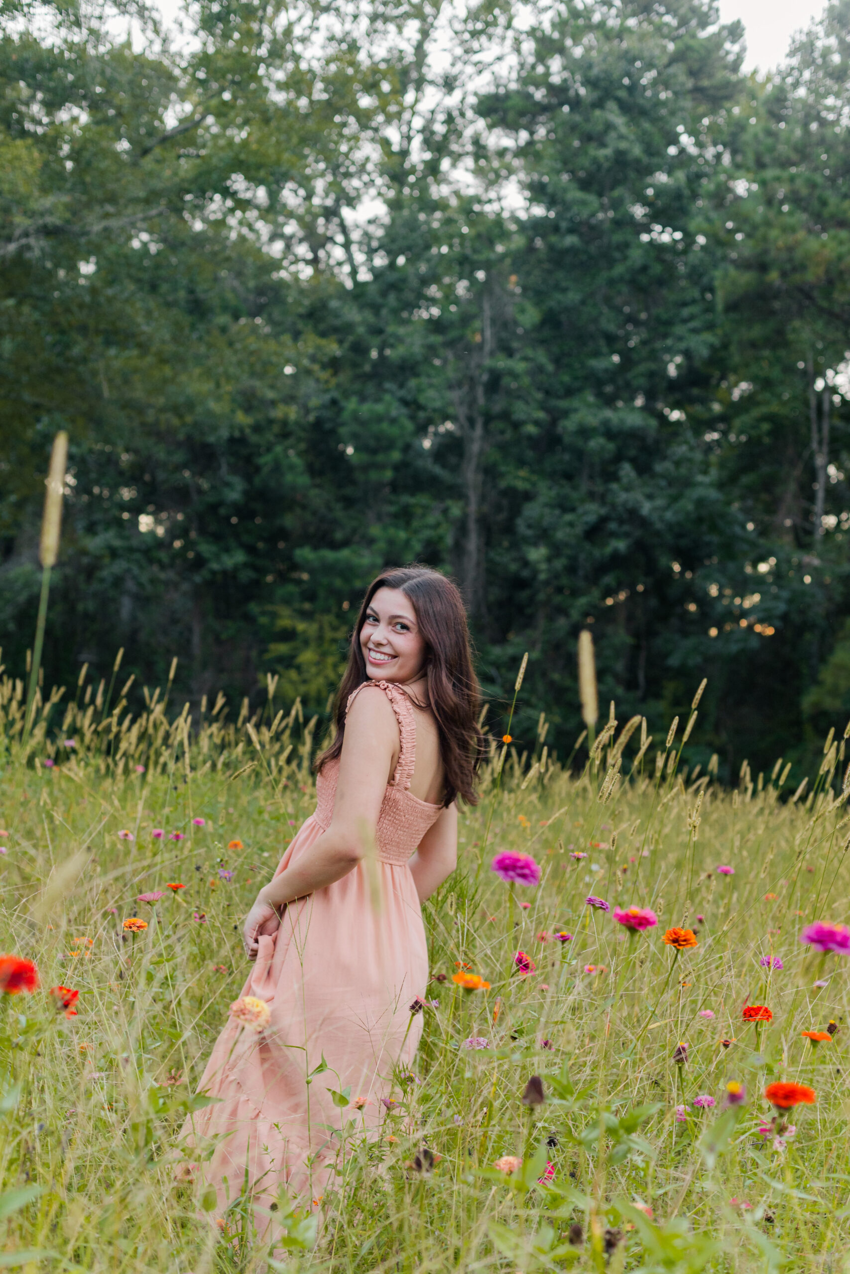 High school Senior girl in a field of flowers for senior portraits