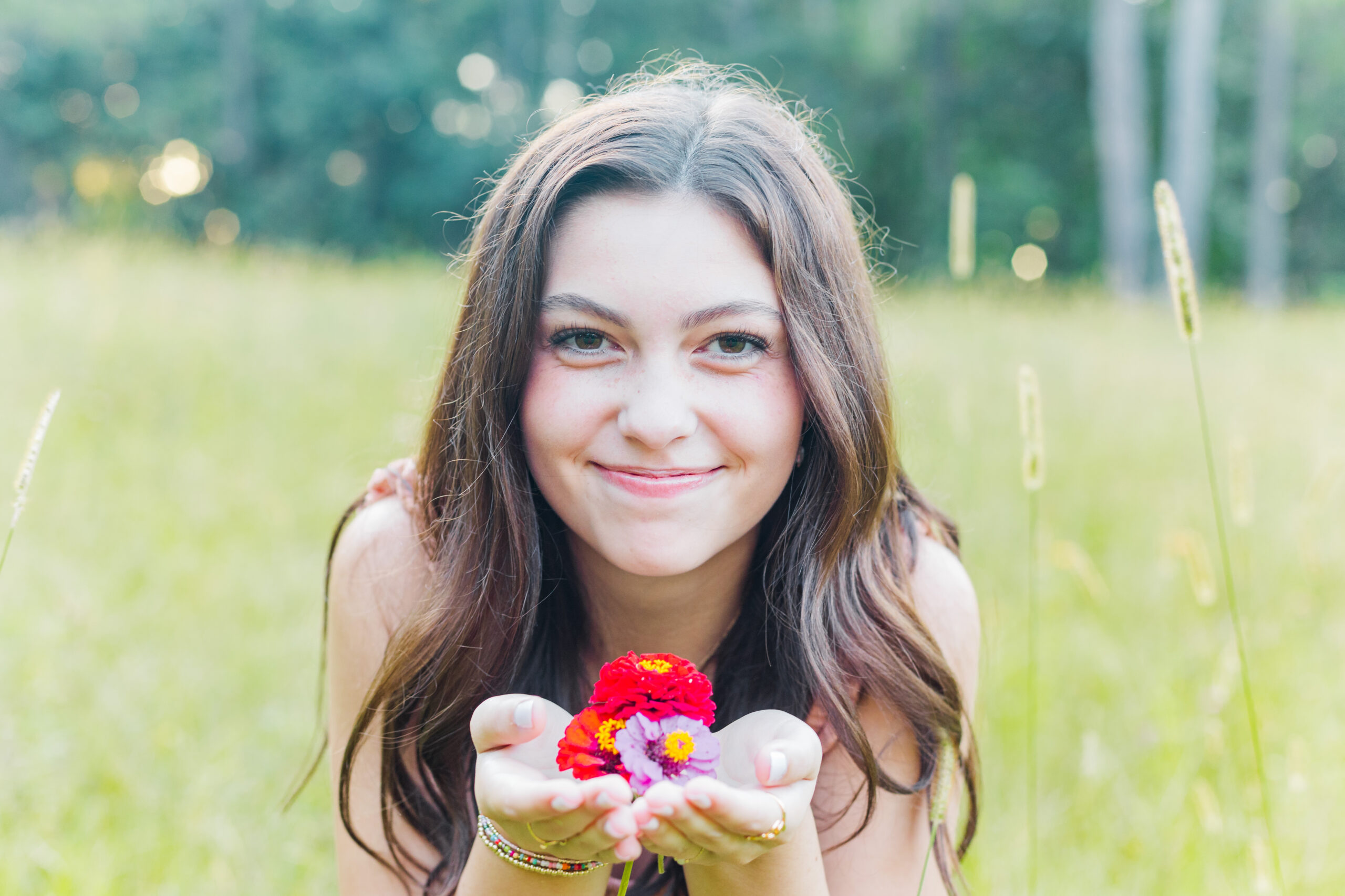 High School Senior in a flower field for senior portraits