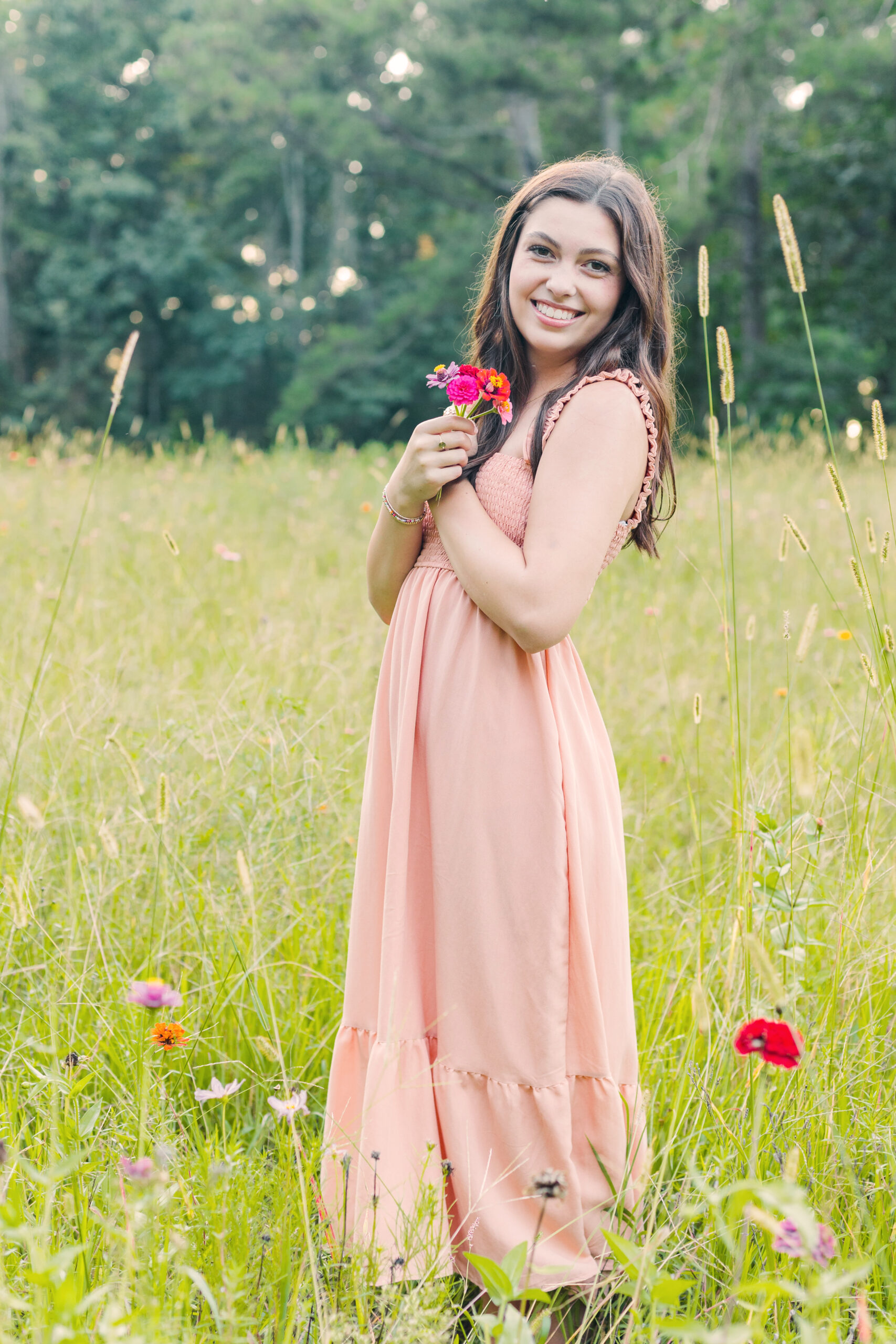 High school senior girl in a flower field for senior portraits